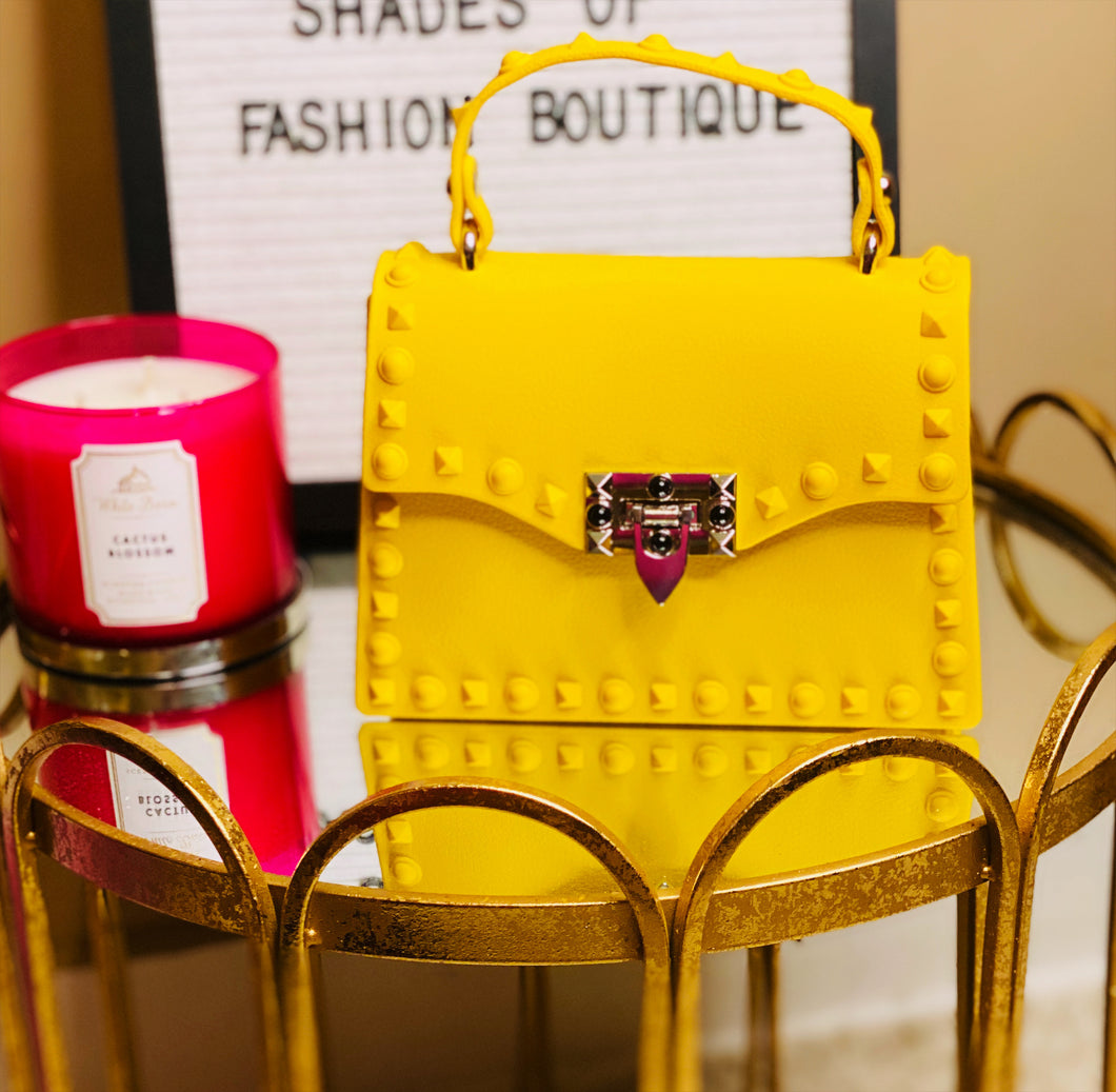 Yellow studded clutch